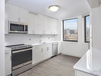 Modern kitchen with stainless steel appliances and city views